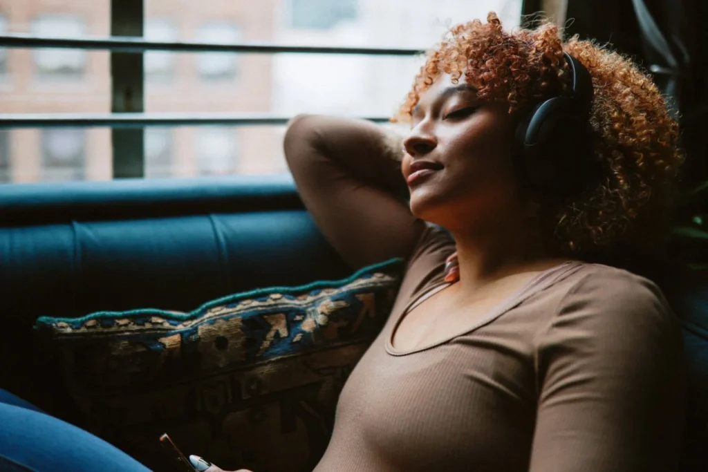 Woman embodying calm presence and emotional balance through gentle self care in a peaceful environment