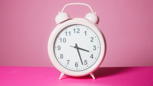 Pink alarm clock symbolizing timing, patience, and trusting your personal growth journey